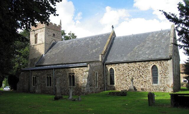 A stone church with a tower and arched windows.