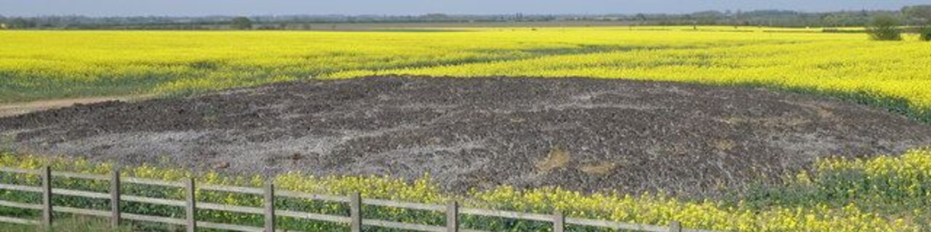 Mega pooh, Great Barford. A favourite on geograph, this has the appearance of a giant cow pat, but the smell says otherwise. Dried bio-solid is the polite term, field stored for autumn application as a fertiliser.