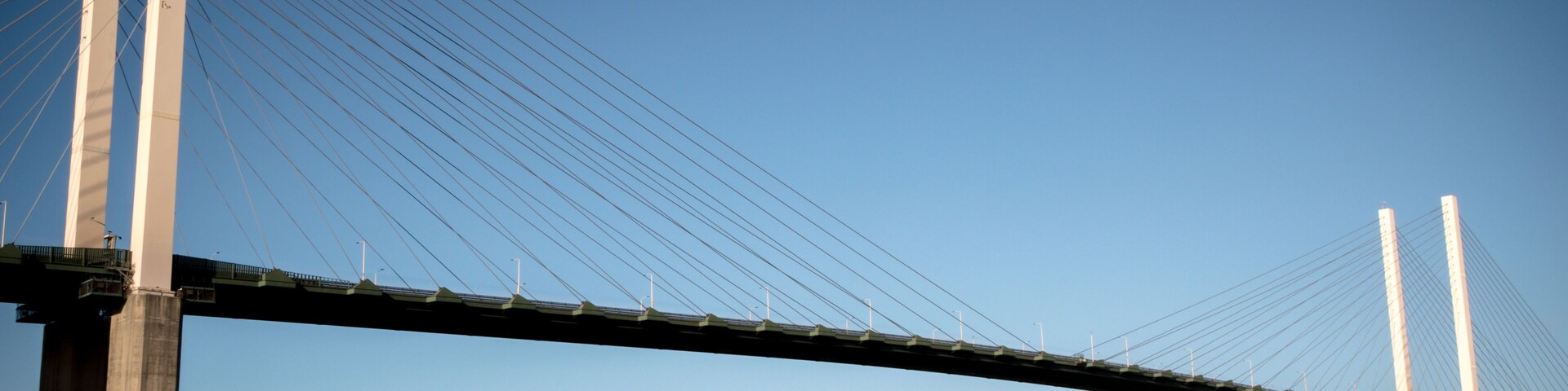 A large suspension bridge with tall towers and cables spanning a body of water.