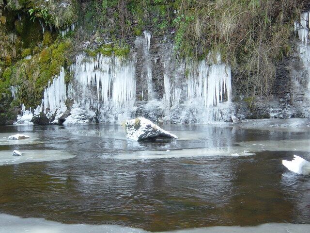 River Greta SE of Brignall Seepage water from the soils of the steep NE-facing slopes of North Wood trickle out over this riverside cliff where cold air rapidly freezes it into ice sheets and icicles.