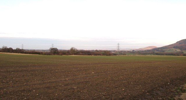 Farmland at East Harlsey There is not much of interest in this square, neither are there many opportunities to enter it. A field track offers access along the southern edge, giving a view across gently undulating farmland towards a line of pylons and the edge of the Cleveland Hills.