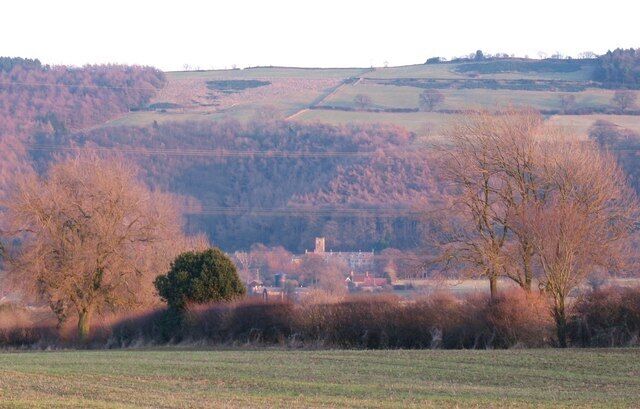 Across the fields to Mount Grace Looking west to east across the grid square towards the ruins of Mount Grace Priory, the tower of which can be seen at the bottom of Swinestye Hill. Between the camera and the priory is a line of pylons [the wires can just be seen] and a busy dual carriageway, which is neither seen or heard from this distance.