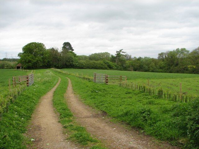The track to the small church hidden in the trees. There is a small church hidden at the end of the track, just to the right of the small disused barn that is just visible