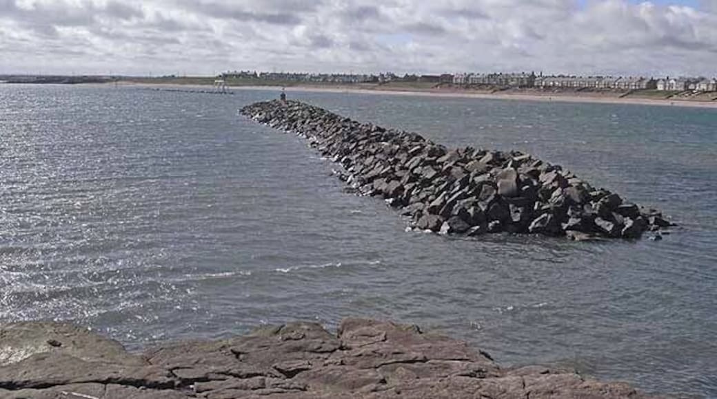 Breakwater, Newbiggin Bay. The two breakwaters at the mouth of Newbiggin Bay were constructed in 2007 to conserve the beach. It is possible to make out the sculpture, Couple on the far breakwater. See 1484759 and other images..