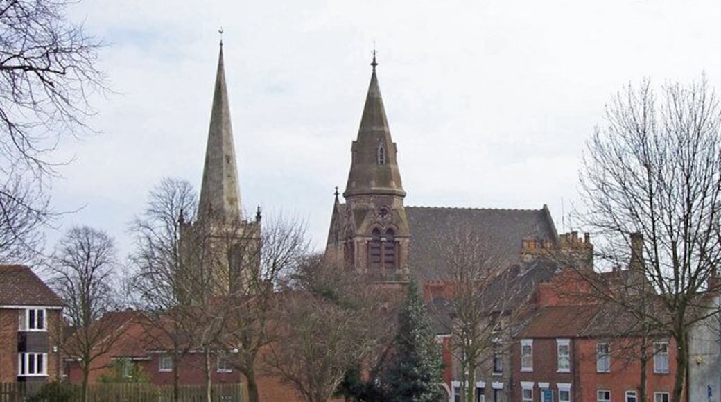 Twin Spires, Hessle, East Riding of Yorkshire, England. On the left is All Saints whilst to the right is the Wesleyan Methodist church. Photo taken from Trinity Grove looking across Tower Hill Memorial Park. Concrete garden bed fence.