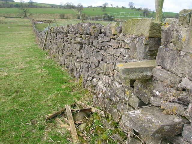 Wall with stile near Stock