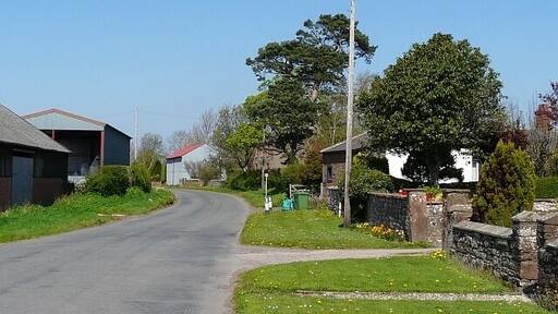 Road through Brisco, near to Brisco, Cumbria, Great Britain. Brisco is a pleasant-looking hamlet about 4km south east of Carlisle. It has several farms and a brickworks.