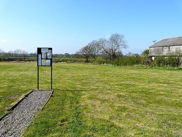 Brisco Common Green open space with a parish noticeboard. Brisco is in the administrative parish of St.Cuthbert Without.