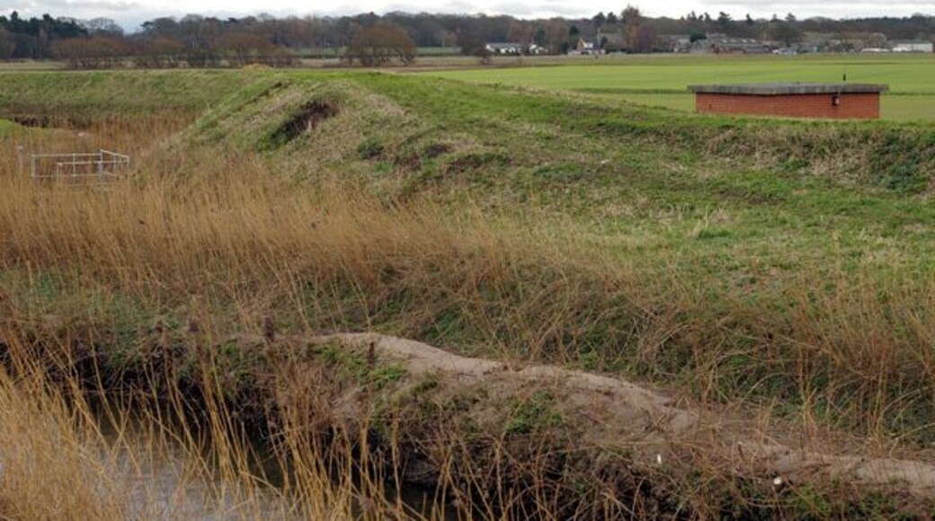 Pumping Station on the River Alt The protective banks stand about three metres above the surrounding land. The land itself would be more marsh than farmland if it weren't for these and the constant pumping of water from the land drains into the river.