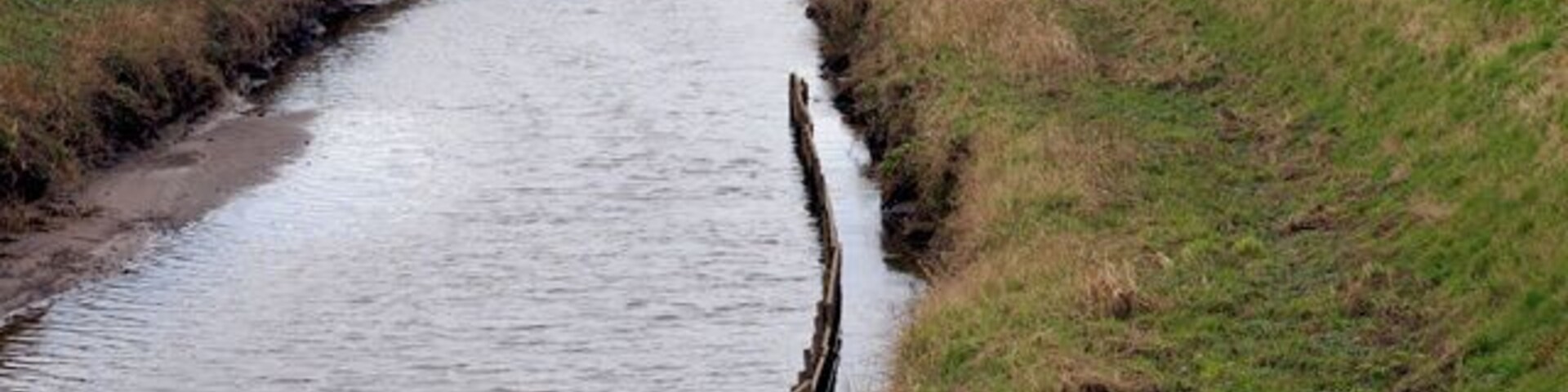 River Alt Note the high banks built to prevent flooding of the surrounding farmland.