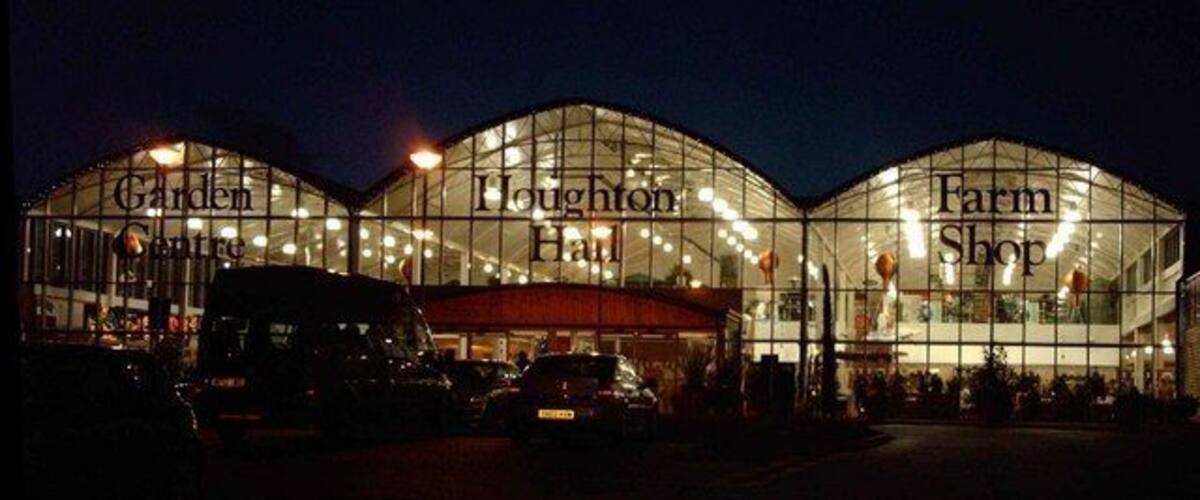 A large glass building with the words "Garden Centre," "Loughton Hall," and "Farm Shop" on its facade.