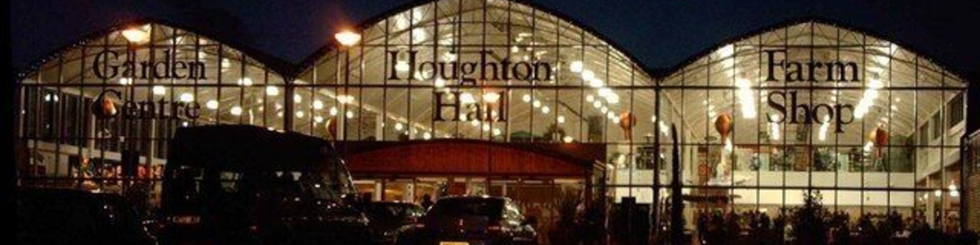 A large glass building with the words "Garden Centre," "Loughton Hall," and "Farm Shop" on its facade.