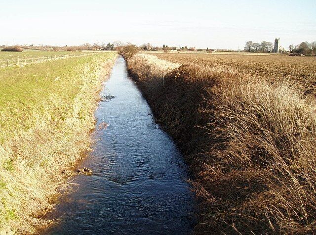 Car Dyke Hawton. This view is of Car Dyke (from the R. Devon) passes under the Hawton to Farndon Road. You can see Hawton Church in the distance.