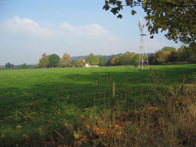 Brock Hill Farm, near Hose, Vale of Belvoir. Wind pump in the foreground, the farmhouse in the centre and Brock Hill behind. This hill is part of the ridge of hills that bounds the Vale of Belvoir on its SE side.
