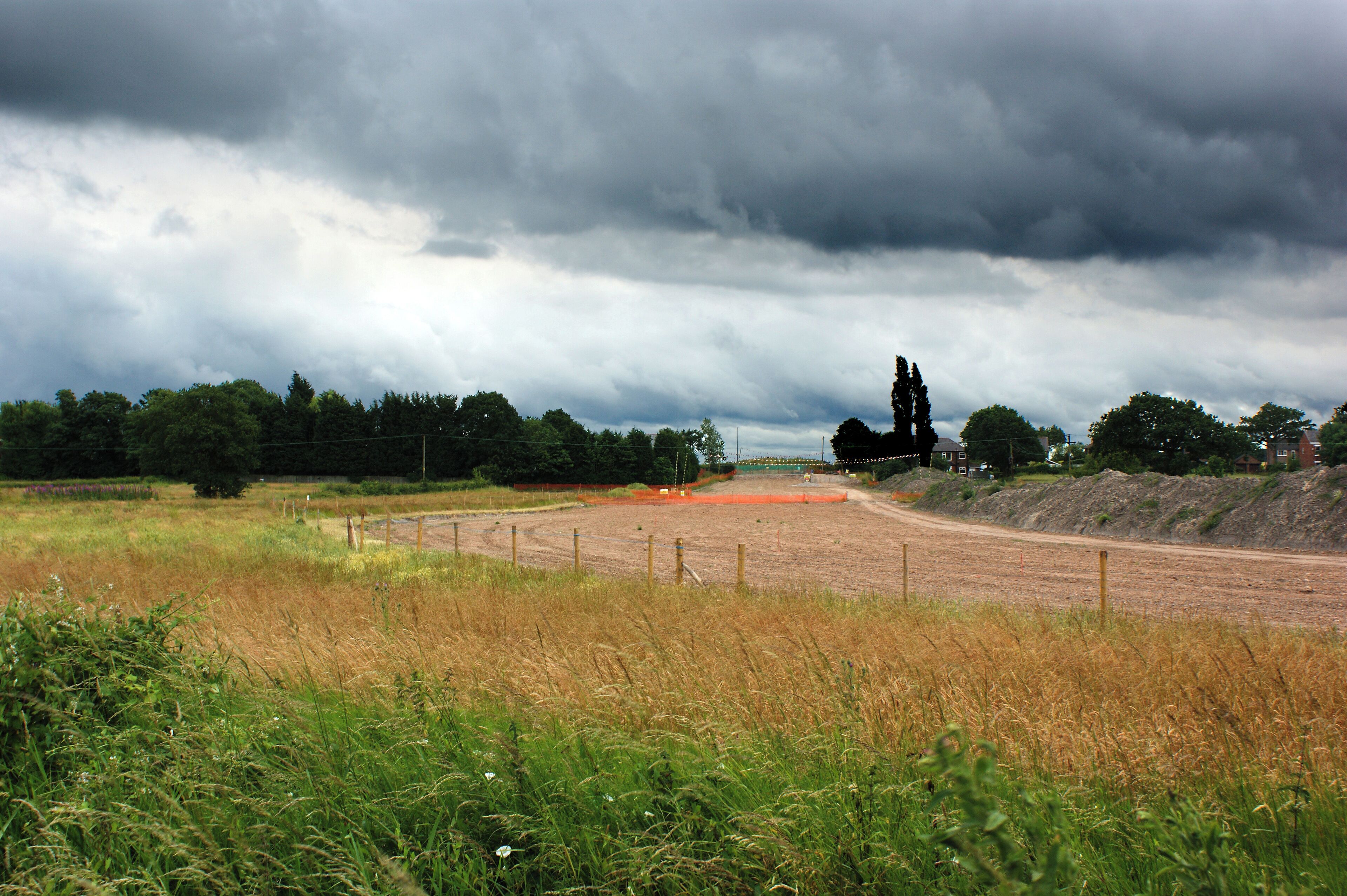 The line of the West East Link Pipeline veers away from the East Lancashire Road, near to Lowton, Wigan, Great Britain. (and the houses at Lowton)