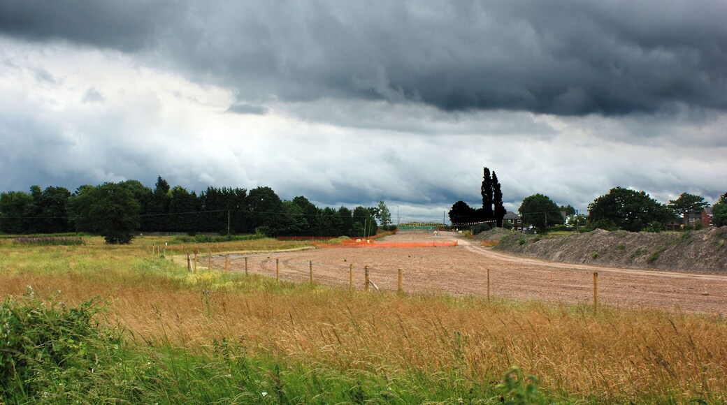 The line of the West East Link Pipeline veers away from the East Lancashire Road, near to Lowton, Wigan, Great Britain. (and the houses at Lowton)
