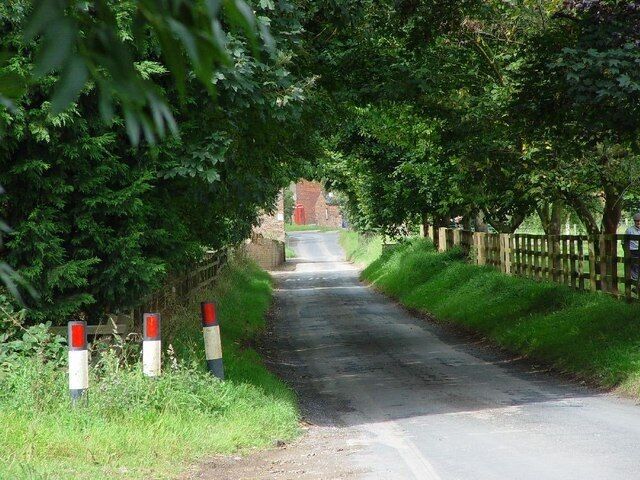 Lockington Road, Lund, East Riding of Yorkshire, England. This eastern approach to Lund takes you directly into the village centre, the BT telephone box being clearly visible.