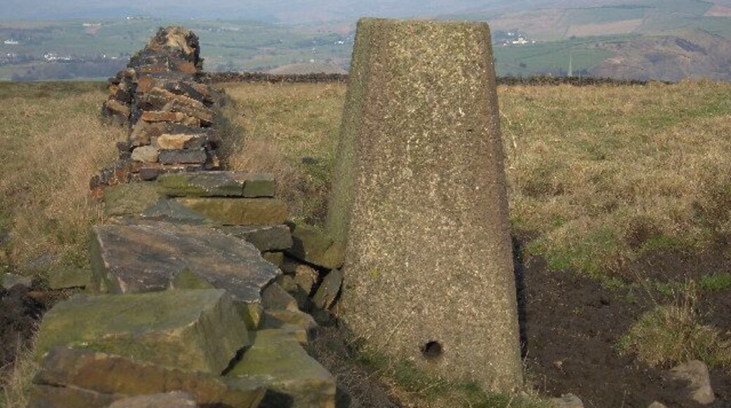 Hey Farm triangulation pillar, 253 metres. Situated just off the Crompton Circuit circular walk not far from Whitfield Hall. Flush bracket no.S2788. View looking north - The spire of Newhey Parish Church can just be seen peeping above the wall to the right of the trig pillar.
