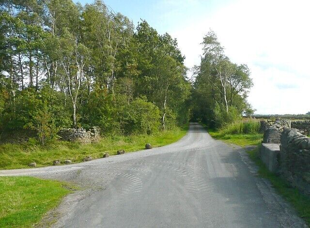 Lane near Huggon, Rathmell. Looking towards Rathmell village from the end of the driveway to Huggon House and Green Farm. There is a milk churn stand on the right.