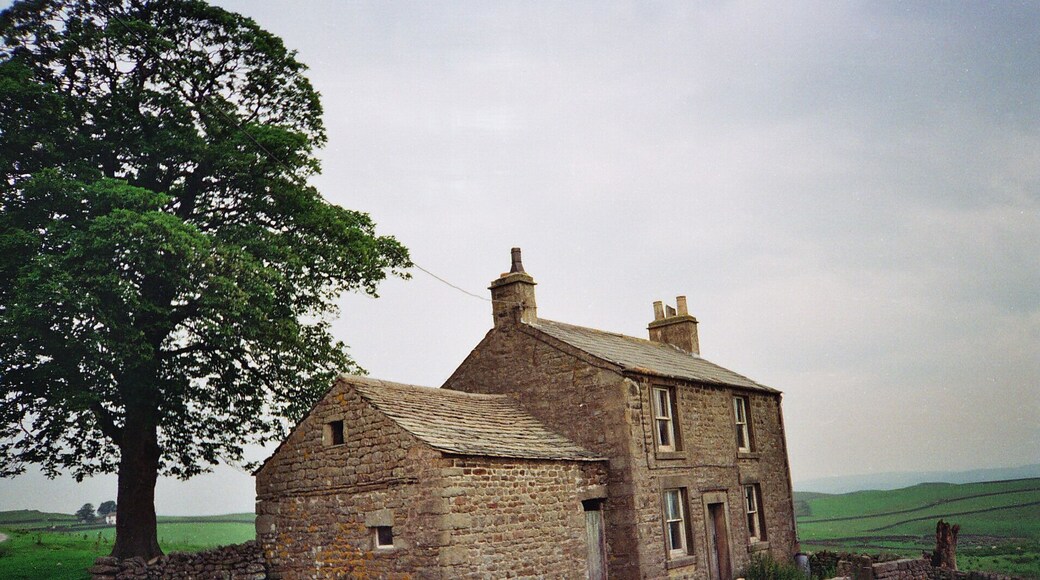 Whelpstone Lodge The old farm house of Whelpstone Lodge. The track in the foreground leads to Owlshaw farm which is the white building in the distance to the left of the tree trunk. The farm track in the picture is officially in Yorkshire but on its short journey to Owlshaw briefly enters back into Lancashire officially. The county boundary being marked by a dry stone wall which the track passes through then after a short distance enters back into Yorkshire through the same wall line. There are no border guards or customs bureaucrats to hassle the free thinking, free roaming poets of the free wild fells. The border line here is part of the 'new'1974 boundary between the Red Rose county of Lancashire and the White Rose of Yorkshire, these being the dictates of control bureaucracies. The old boundary bit deep into the 'Red Rose' making Lancashire geographically resemble a wasps body! The extremity of the 'White Rose' bite was on the high fells of Bowland over looking the Irish sea which was just 9 miles west along SD51 grid line to the coast at Morecambe Bay. This old county boundary area was near 'Greave Clough Head' and 'White Moss' at 1520ft(464M) both being in SD5750. The western extremity of this former boundary is marked on the map as a mound at SD574509 just south of 'Johnny Pye's Clough Top'. Johnny Pye's Clough Top is in SD5751 which also lies on the old county boundary line marked by another mound a short distance towards the north east. A little further on still (NE) the trig point of 'Hawthornthwaite Fell Top' 1567ft (476M) SD579515 was on the former Lancashire/Yorkshire border. Many of us free spirits do not recognise these 'new' 1974 border lines and still refer to villages and places as being in the Red Rose or White rose counties of former times pre 74, even if it does make old Lancashire take the form of a wasps body. Also don't forget we Lancastrians had the south peninsulas of the Lake District dipping into the north of Morecambe Bay. But Yorkshire men and women are wary of us Lancashire folk because they know we have a damned good sting !
