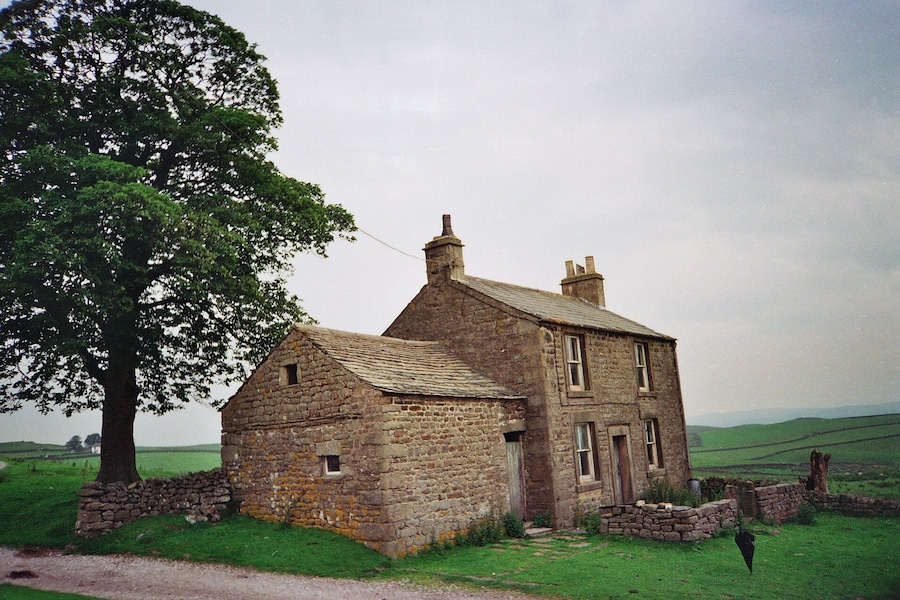 Whelpstone Lodge The old farm house of Whelpstone Lodge. The track in the foreground leads to Owlshaw farm which is the white building in the distance to the left of the tree trunk. The farm track in the picture is officially in Yorkshire but on its short journey to Owlshaw briefly enters back into Lancashire officially. The county boundary being marked by a dry stone wall which the track passes through then after a short distance enters back into Yorkshire through the same wall line. There are no border guards or customs bureaucrats to hassle the free thinking, free roaming poets of the free wild fells. The border line here is part of the 'new'1974 boundary between the Red Rose county of Lancashire and the White Rose of Yorkshire, these being the dictates of control bureaucracies. The old boundary bit deep into the 'Red Rose' making Lancashire geographically resemble a wasps body! The extremity of the 'White Rose' bite was on the high fells of Bowland over looking the Irish sea which was just 9 miles west along SD51 grid line to the coast at Morecambe Bay. This old county boundary area was near 'Greave Clough Head' and 'White Moss' at 1520ft(464M) both being in SD5750. The western extremity of this former boundary is marked on the map as a mound at SD574509 just south of 'Johnny Pye's Clough Top'. Johnny Pye's Clough Top is in SD5751 which also lies on the old county boundary line marked by another mound a short distance towards the north east. A little further on still (NE) the trig point of 'Hawthornthwaite Fell Top' 1567ft (476M) SD579515 was on the former Lancashire/Yorkshire border. Many of us free spirits do not recognise these 'new' 1974 border lines and still refer to villages and places as being in the Red Rose or White rose counties of former times pre 74, even if it does make old Lancashire take the form of a wasps body. Also don't forget we Lancastrians had the south peninsulas of the Lake District dipping into the north of Morecambe Bay. But Yorkshire men and women are wary of us Lancashire folk because they know we have a damned good sting !