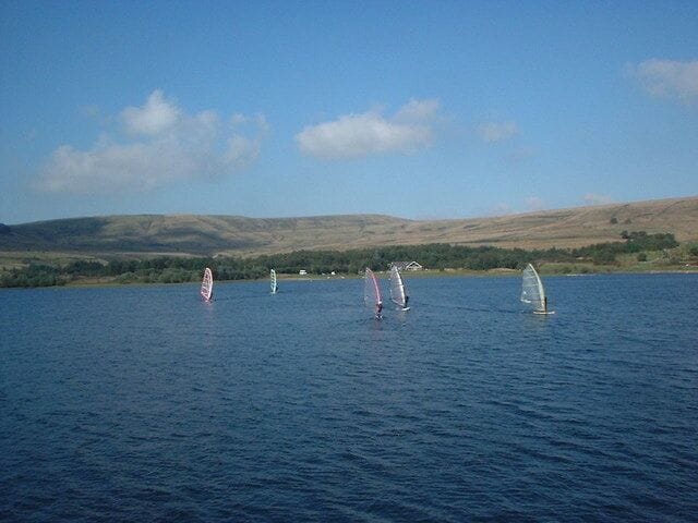 Watergrove windsurfers Taken from the reservoir dam, the subject is the windsurfers' clubhouse on the far side of the reservoir. Watergrove in winter: https://www.geograph.org.uk/photo/1701104