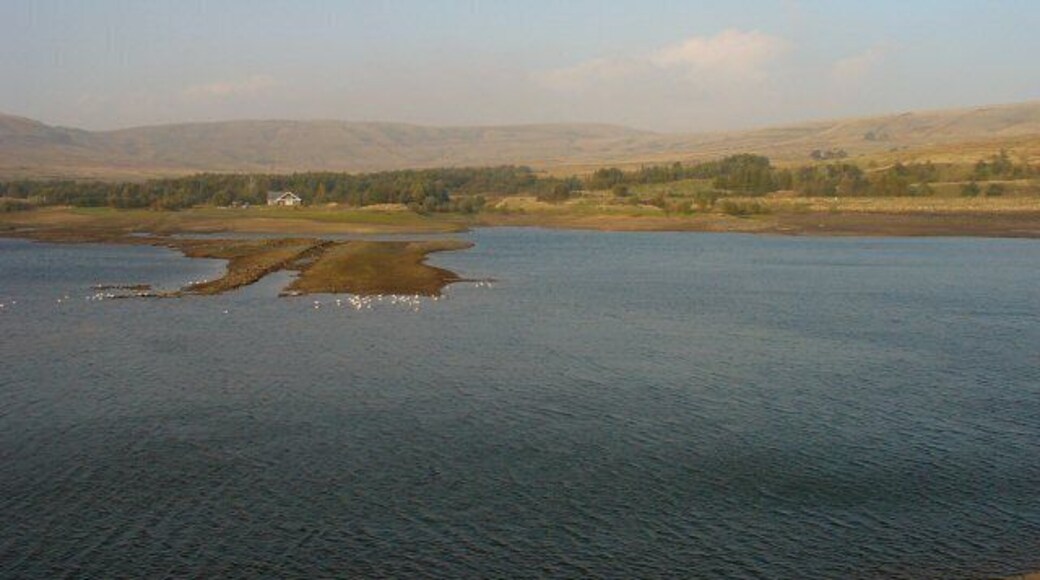 Watergrove Reservoir, Lancashire. View of the reservoir, looking N from the top of the dam. The car park is behind the photographer. The water is very low and the line of the old road that used to give access up the valley can be seen in the temporary island in the reservoir.