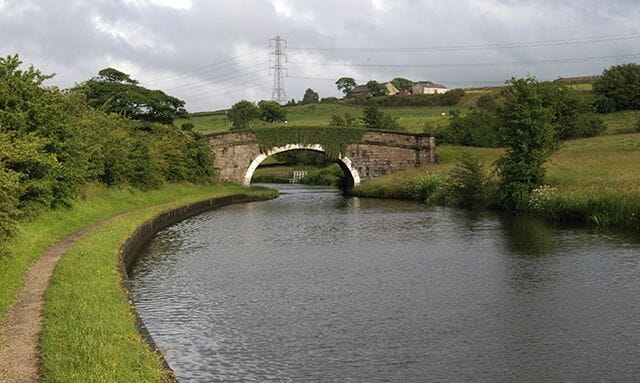 Millfield Bridge This crossing of the Leeds Liverpool canal is currently fenced at the northern end to prevent livestock crossing. On the horizon is Stanworth Farm.