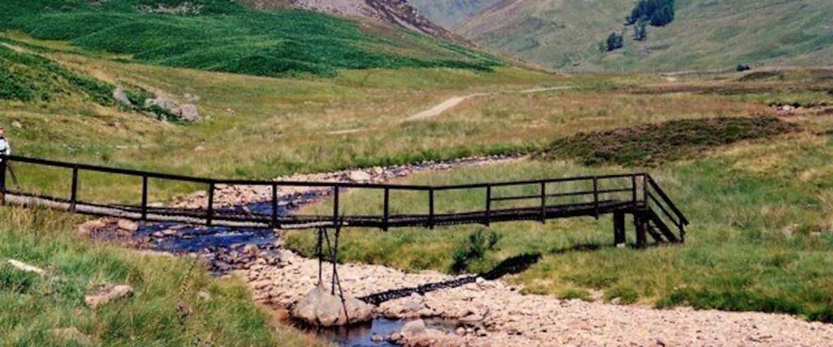 Footbridge in Glen Isla Wooden footbridge in a rather decayed state. Not the safest way to cross the River Isla.