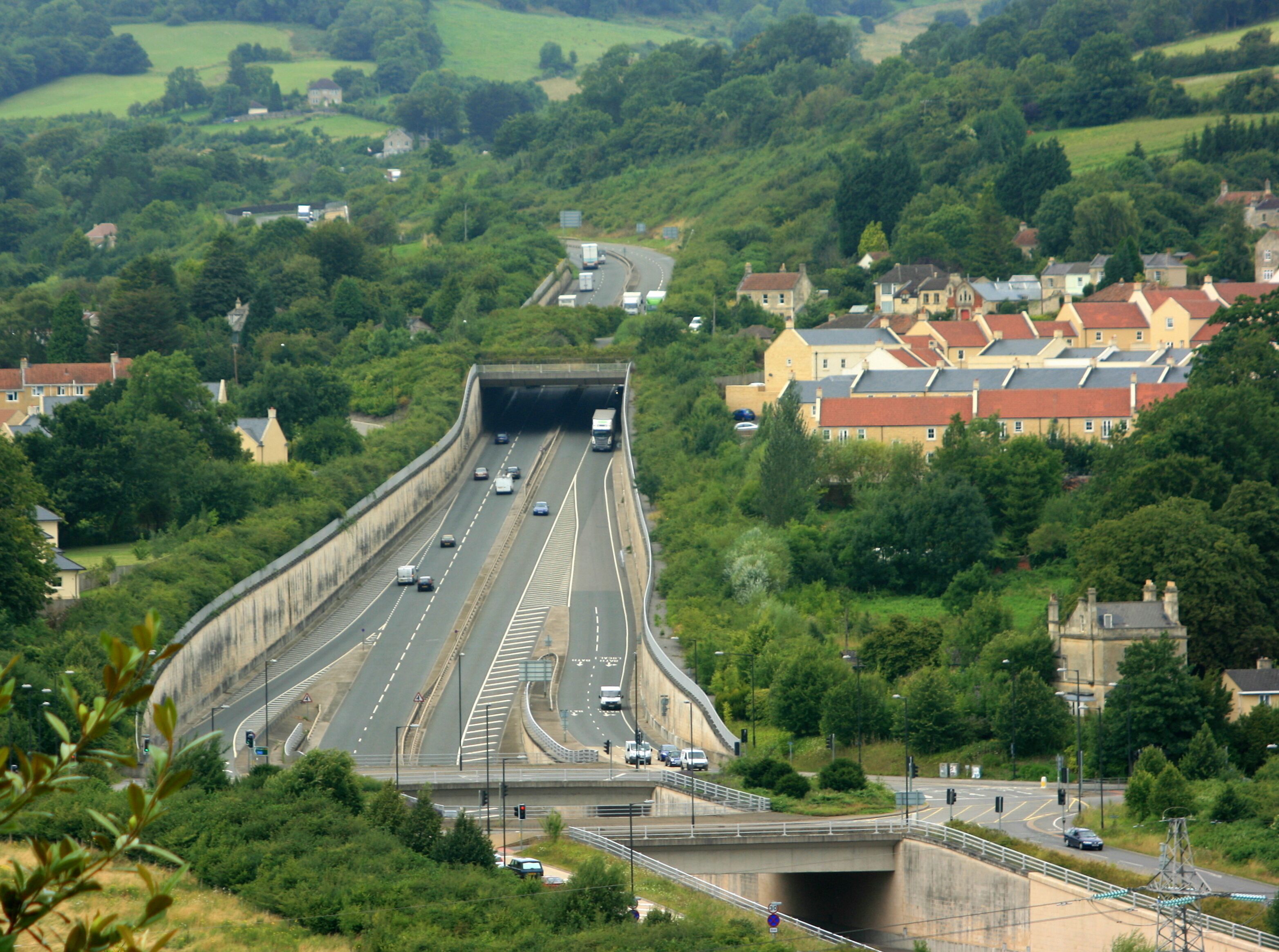 North from Bathampton. A view of the realigned A46 from Warminster Road on the other side of the River Avon. Bailbrook stands out on the right with a corner of Lower Swainswick to the left. See 875677