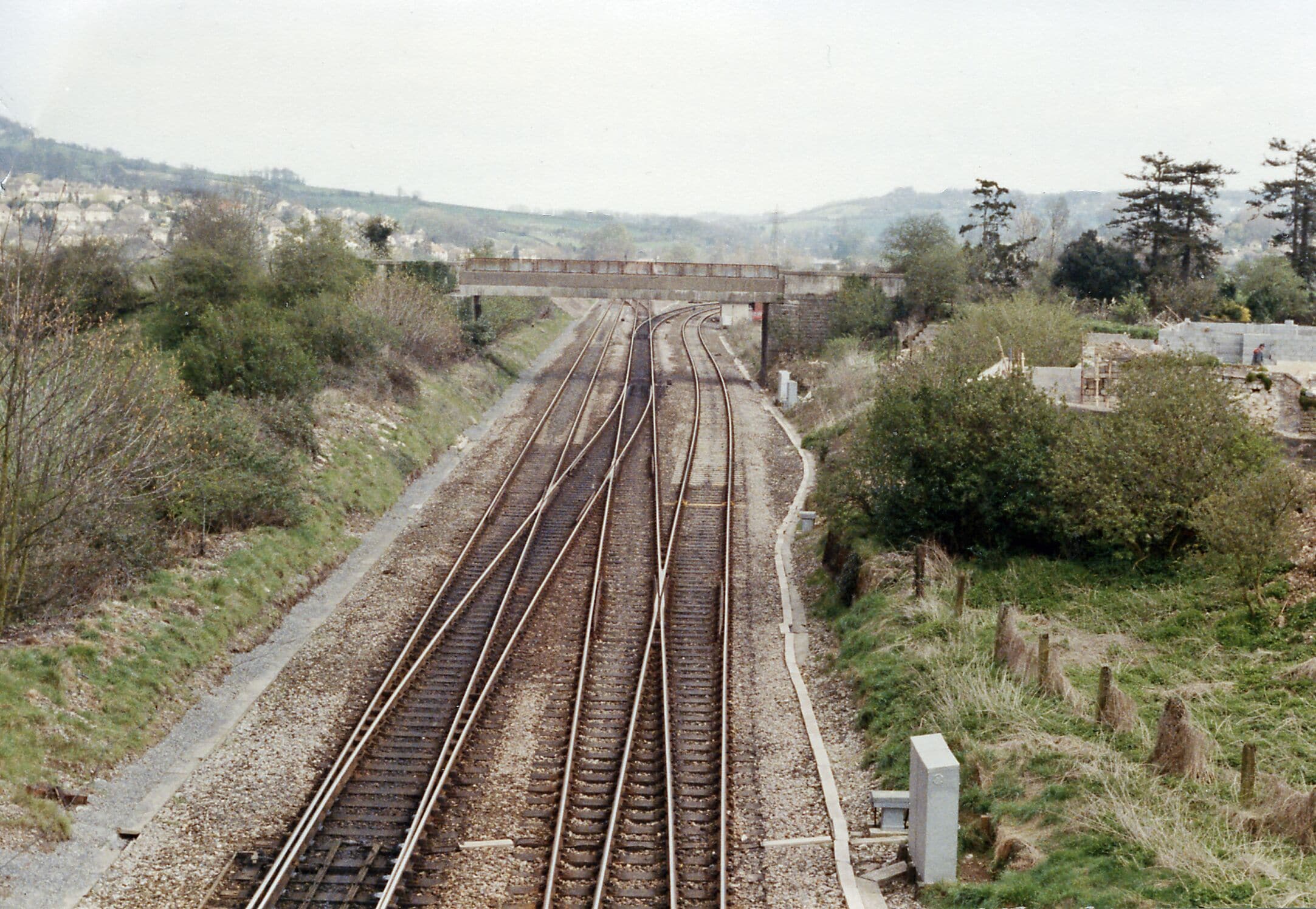 Site of Bathampton station, 1989. View eastward, towards Chippenham, Swindon etc. on the ex-GWR Bristol - Bath - London main line, also - diverging sharp-right - the secondary main line to Westbury and Salisbury. The station was closed from 3/10/66.