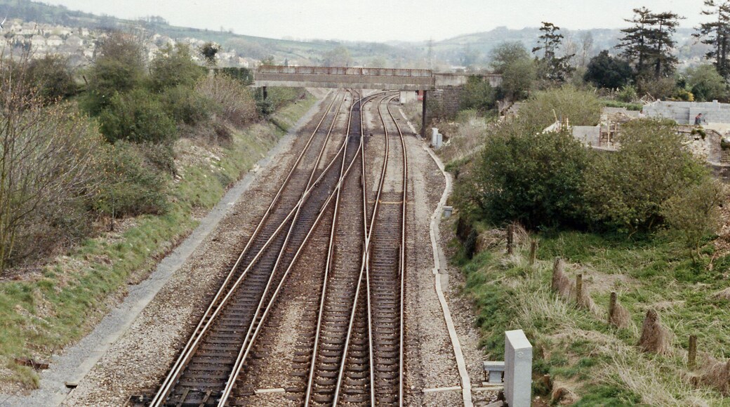 Site of Bathampton station, 1989. View eastward, towards Chippenham, Swindon etc. on the ex-GWR Bristol - Bath - London main line, also - diverging sharp-right - the secondary main line to Westbury and Salisbury. The station was closed from 3/10/66.