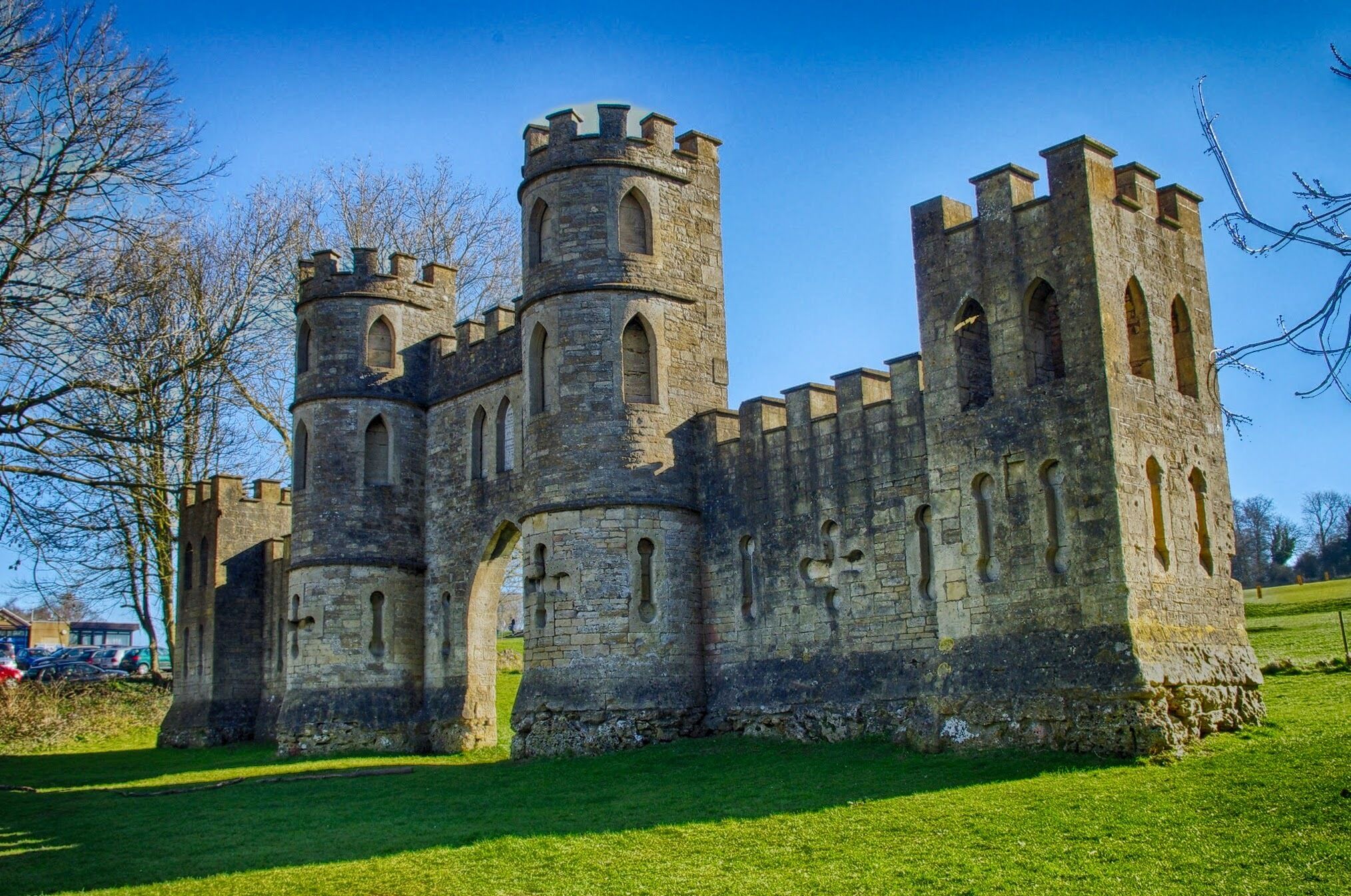 A historic stone castle with multiple towers and arched windows.