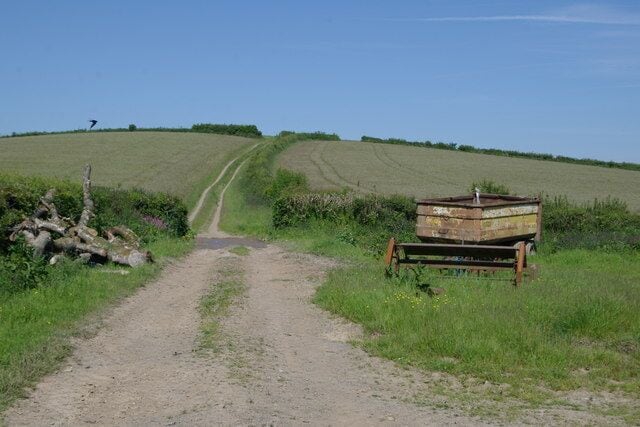 Farm track at Holwood. Farm track and rusty farm trailer near Holwood, Blunts, Cornwall.