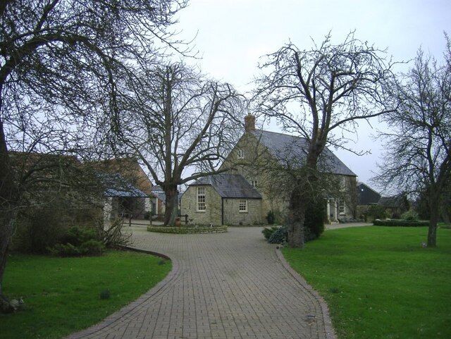 Shades farm A suburban-style driveway leads to this traditional farmhouse.