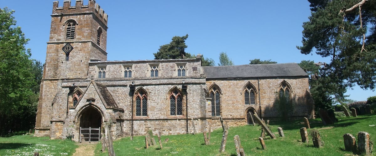 A historic church with a tall tower and arched windows.