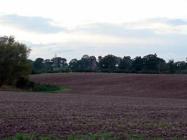 Ploughed field and the view to the mill at Butter Hill House. Looking from the lane from The Toft to Coppenhall. The mill among the trees is at SJ898181