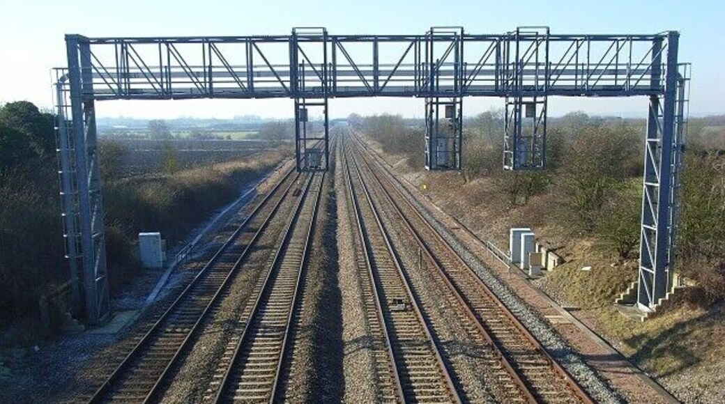 Railway near Grove The view west from Denchworth Road Bridge is immediately interrupted by a signal gantry for eastbound trains.