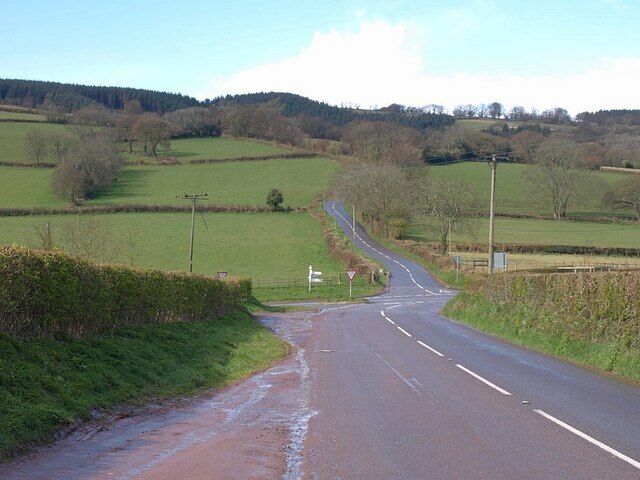 Elworthy Cross The B3224 from Bishop's Lydeard drops to cross the B3188. The slightly offset crossroads is actually on a col; to the left the combe drains south towards the Tone, to the right, north to the Doniford Water.