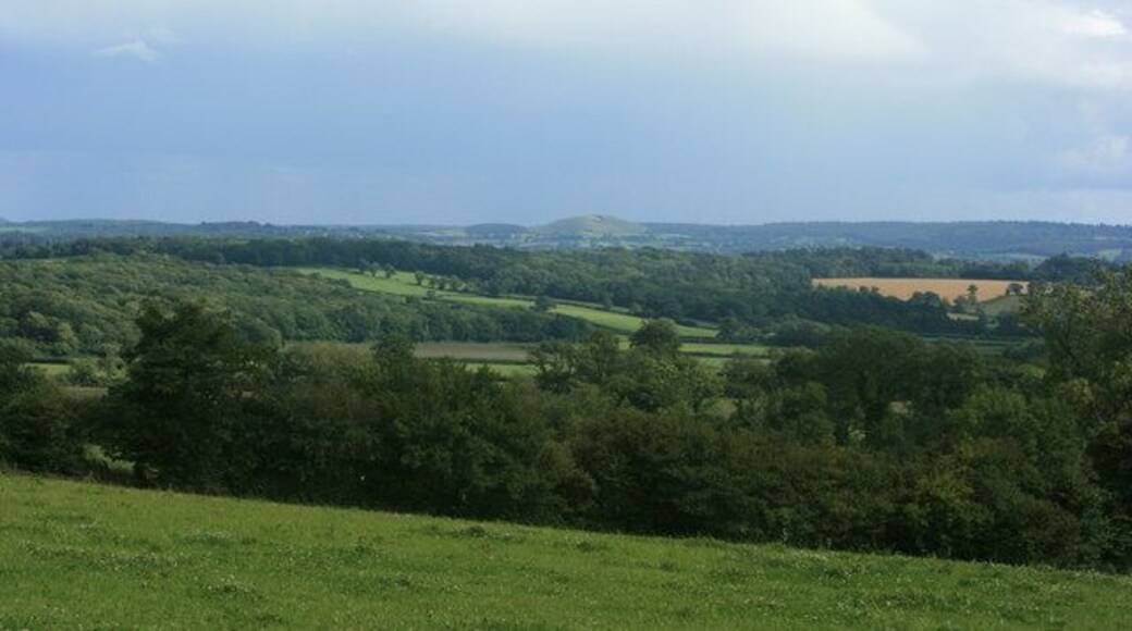 South east from Fulwell Lane Where it crosses Chickwell Lane. The scene is darkened by an approaching thunderstorm but Cley Hill ST8344 is far enough to find a gap in the clouds.