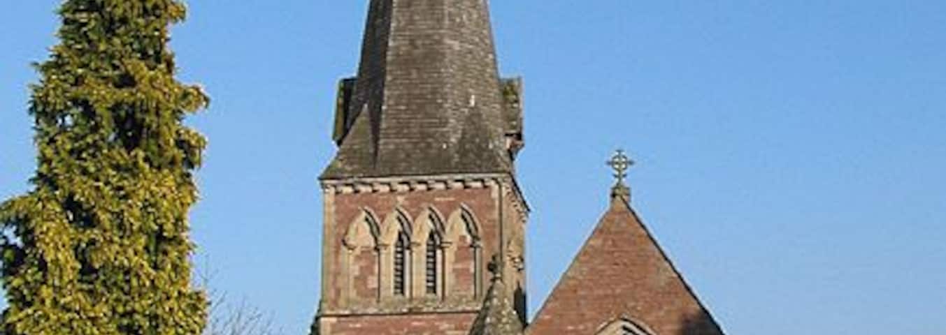 Western facade of the Church of St. Mary the Virgin, Flaxley Was originally a gateway chapel of a Cistercian Abbey and became a church following the Dissolution. Rebuilt in 1856 of red grit with forest stone.