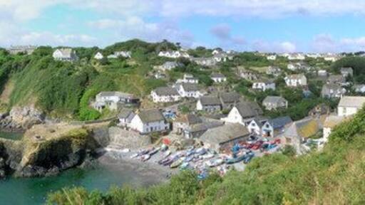 Panoramic view of Cadgwith looking towards Lizard Point The white marquee just visible in the horizon on the far left is the venue for the wedding of the century, James and Jo, 12th August 2006