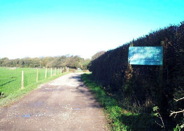 Lane to Lilstock beach. Access to the beach car park is via a private road. The sign details what conditions there are for its use by the general public. The photograph is taking looking north at the junction with the lane to Lilstock.