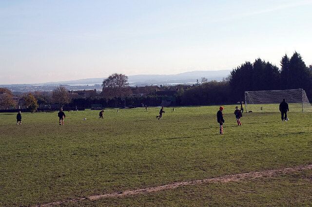 Lytchett Matravers Recreation Ground, Dorset. Sunday morning soccer practice. Poole Harbour is in the distance.