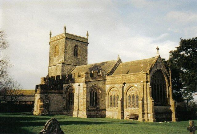 A historic church with a prominent tower and arched windows.