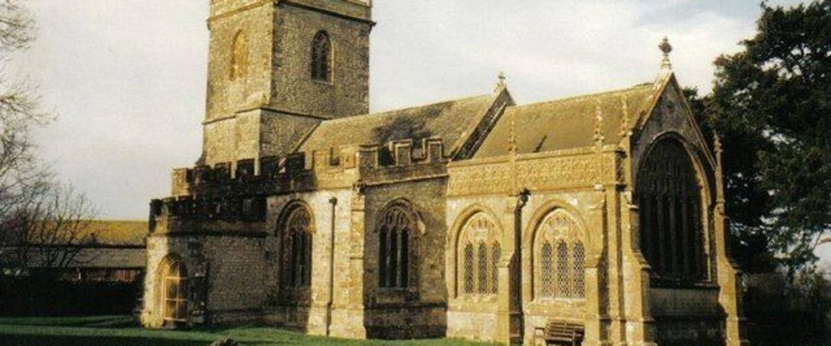 A historic church with a prominent tower and arched windows.
