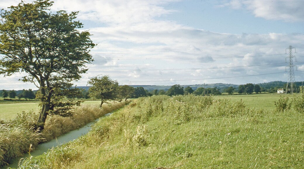 Northward along stream from near St Pierre Pill to Pill Cottage and towards Mathern. View northwards from beside the railway east of Portskewett station to the hills west of Chepstow. The railway is just behind and on its other side is the Severn Estuary.