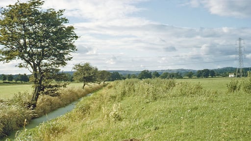 Northward along stream from near St Pierre Pill to Pill Cottage and towards Mathern. View northwards from beside the railway east of Portskewett station to the hills west of Chepstow. The railway is just behind and on its other side is the Severn Estuary.