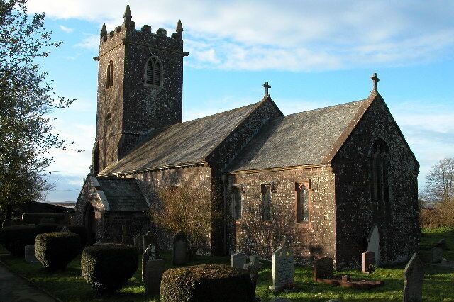 A church with a tall tower and a graveyard.