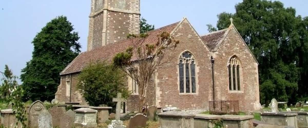 St James the Great, Westerleigh. A gateway from the recreation field to the south of the church into the churchyard, carries the dates "1304 - 2004" - this probably indicates the date of the earliest parts of this church - which I would hazard do not include most of what you see in this picture. The tower in particular looks Victorian to me. What I think is the oldest part of the church can be seen here 464276.